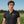 Young man in a black polo shirt with a logo on a golf course